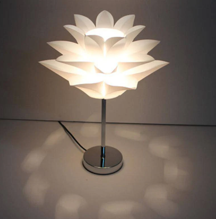 Smukła lampa stołowa o sylwetce inspirowanej płatkami kwiatu lotosu