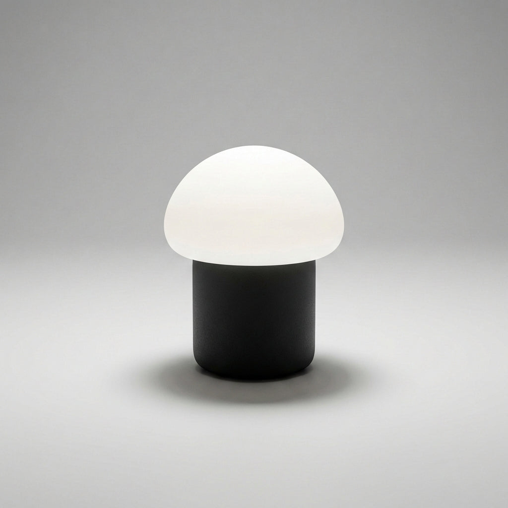 Minimalistyczna kompaktowa lampa stołowa z sylwetką grzyba i obciążoną podstawą