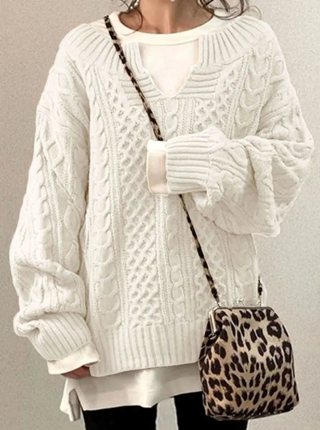 Damski oversize’owy sweter z dzianiny w warkoczowy splot z dekoltem w serek